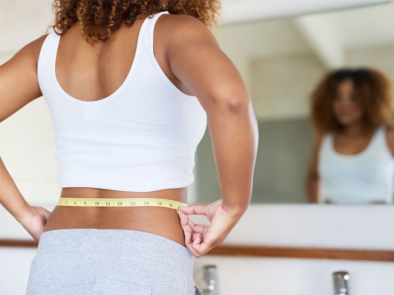 Women measuring her waist 